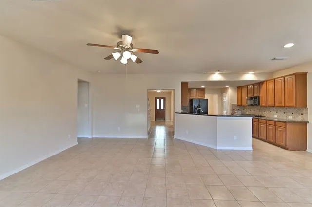 a view of a kitchen with a sink and refrigerator