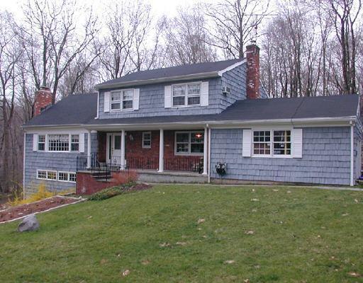 55 Daffodil Road Stamford, CT 06903 - Photo 1 of 1 front view of a brick house with a yard lawn chairs and a large window