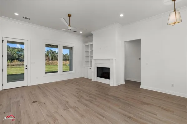 an empty room with a fireplace and cabinet
