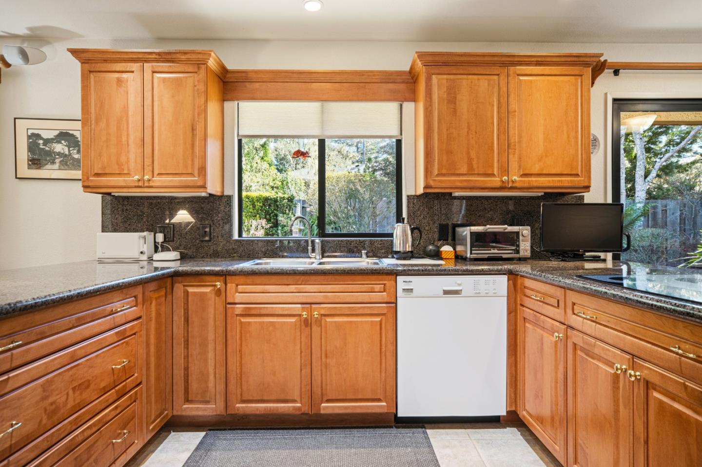 2911 Colton Road Pebble Beach, CA 93953 - Photo 14 of 46 a kitchen with stainless steel appliances granite countertop a refrigerator a sink dishwasher a stove and white countertops with cabinets