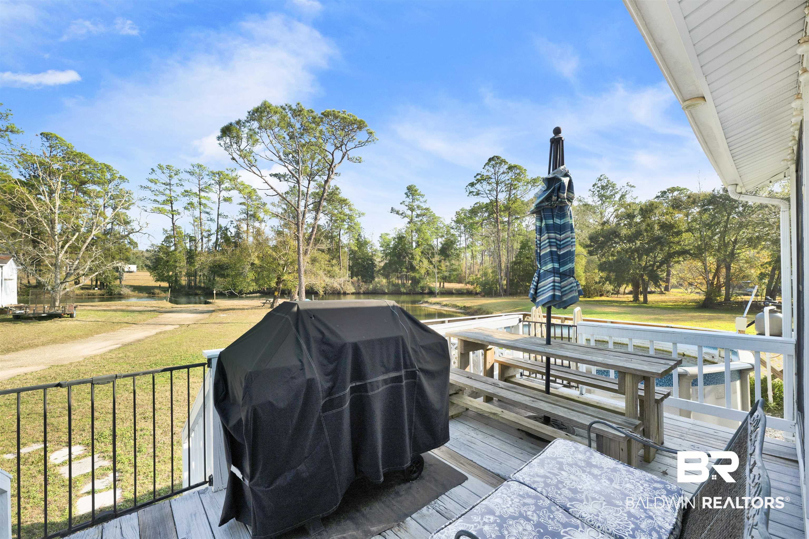 23770 Miflin Road Elberta, AL 36530 - Photo 17 of 38 Wooden terrace with area for grilling, a yard, and view of wooded area