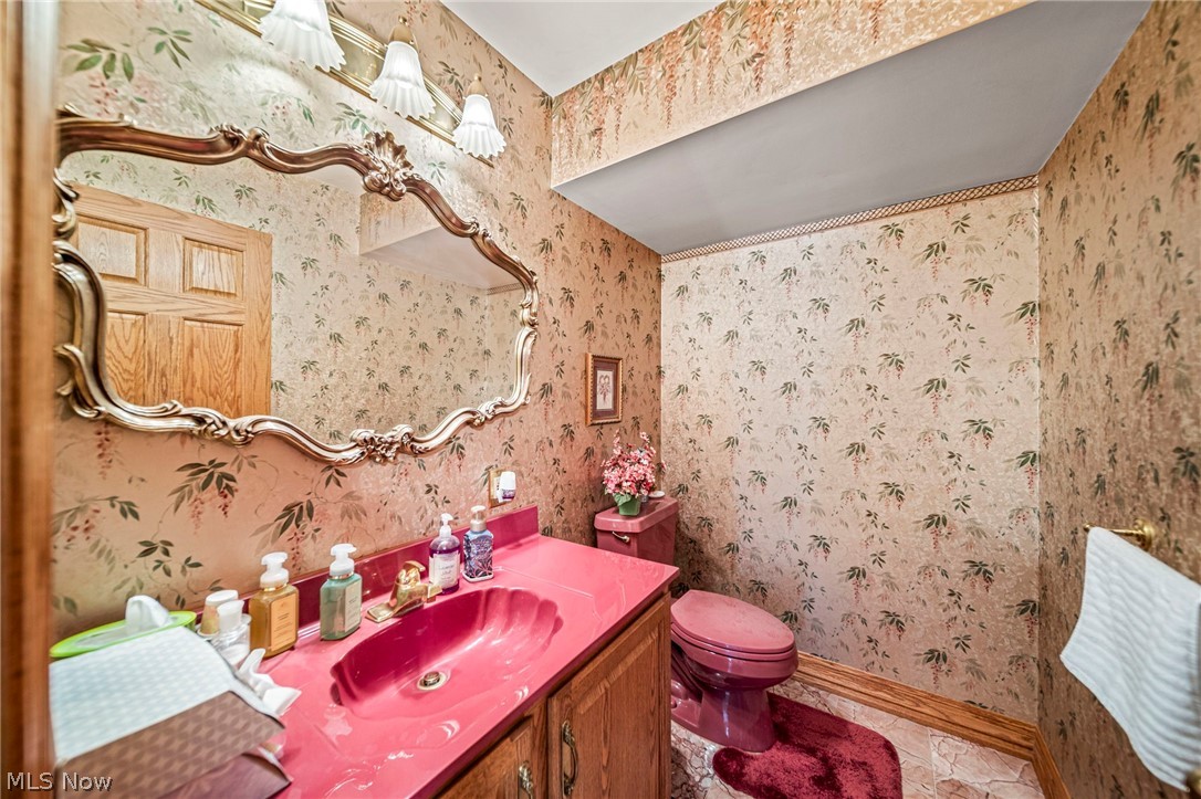 8801 Bunker Road Orwell, OH 44076 - Photo 18 of 50 Half bath with wallpapered walls, vanity, and light tile patterned floors