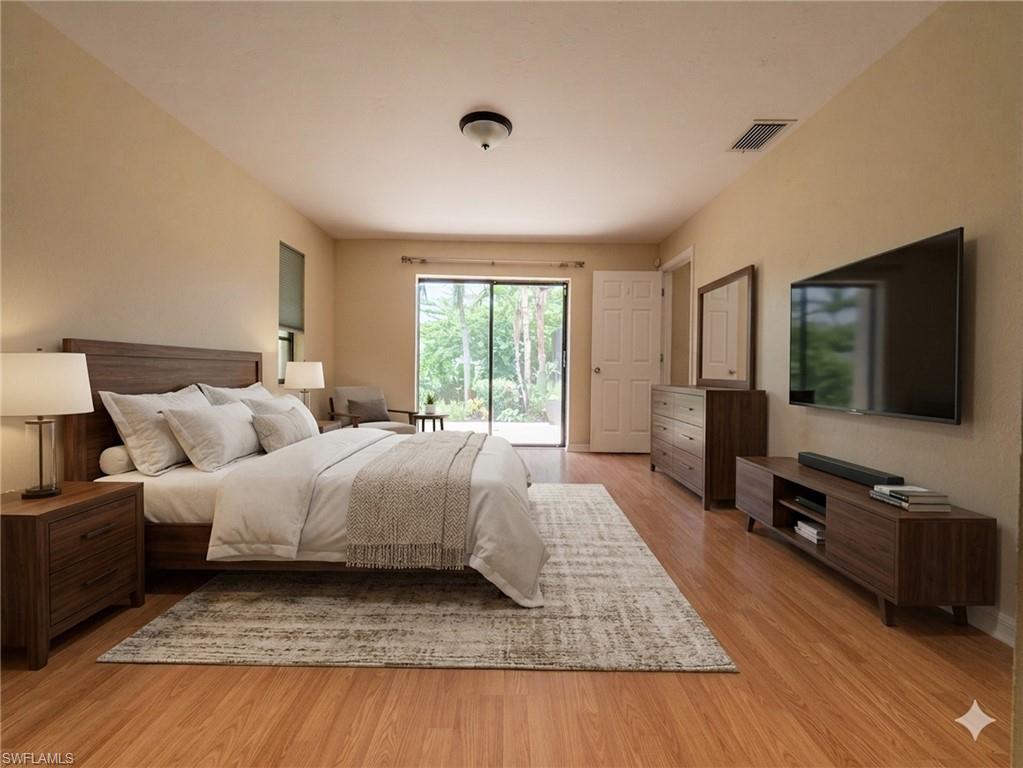 18414 Tulip Road Fort Myers, FL 33967 - Photo 20 of 37 Spacious bedroom featuring wood-finish flooring, a ceiling-mounted light fixture, and beige wall paint