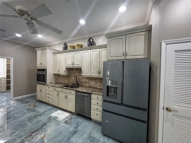 a view of kitchen with refrigerator stove and oven