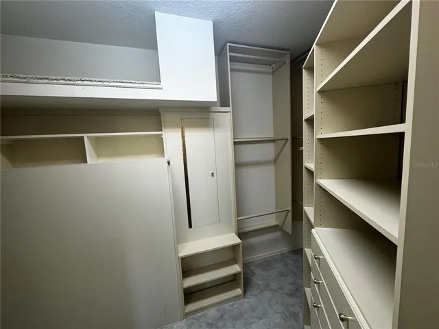 a bathroom with a granite countertop sink a mirror and shower