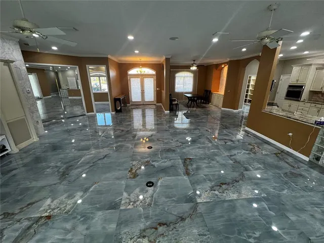 a view of a lobby with floor to ceiling window and kitchen