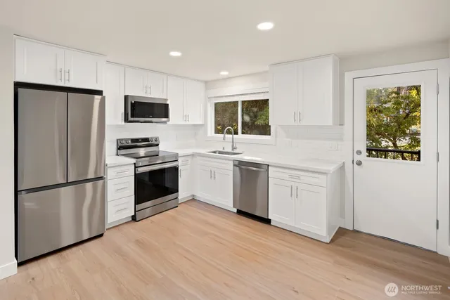 a view of a kitchen with refrigerator and microwave