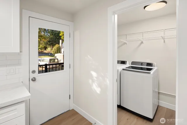 a view of kitchen with stainless steel appliances refrigerator stove microwave and cabinets