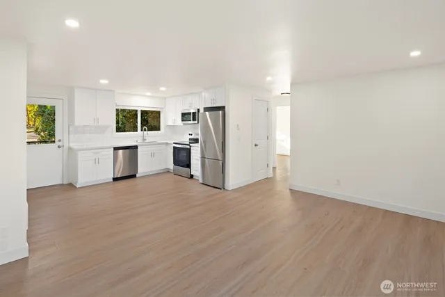a kitchen with white cabinets and white stainless steel appliances
