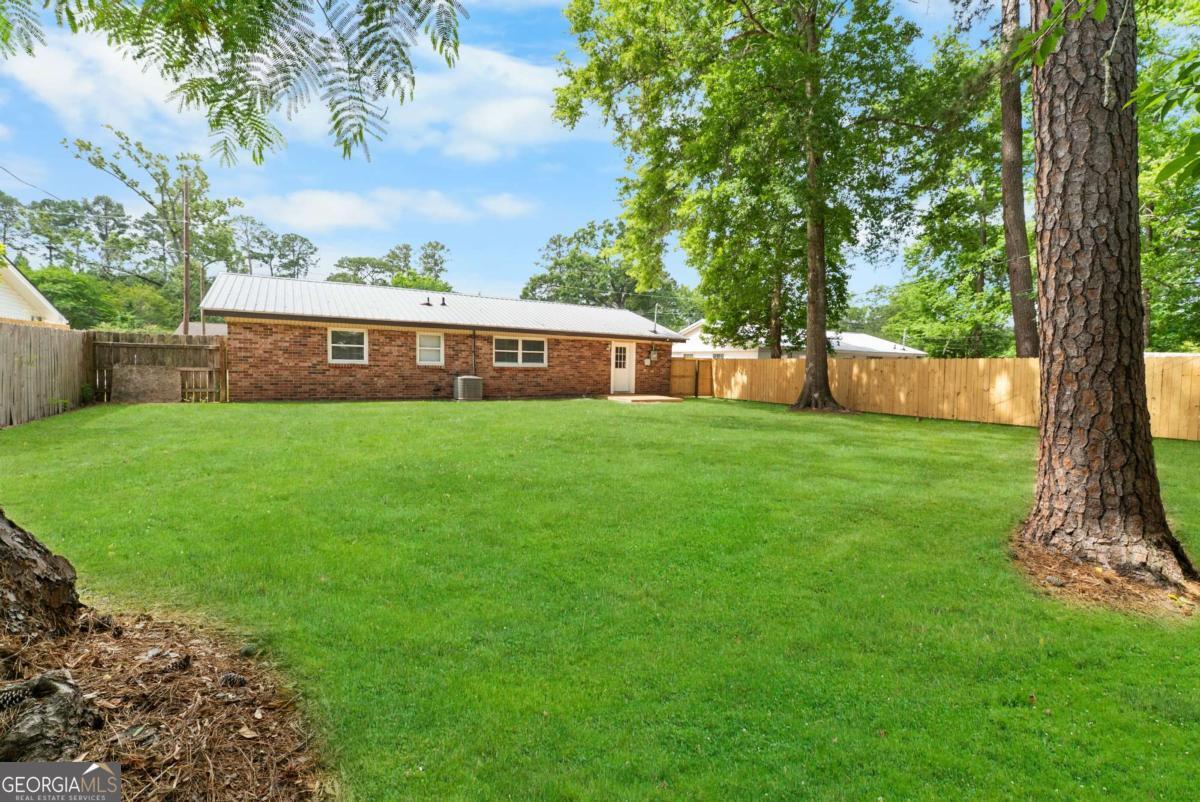 320 West Whatley Street Pooler, GA 31322 - Photo 31 of 34 a view of a house with a yard and sitting area