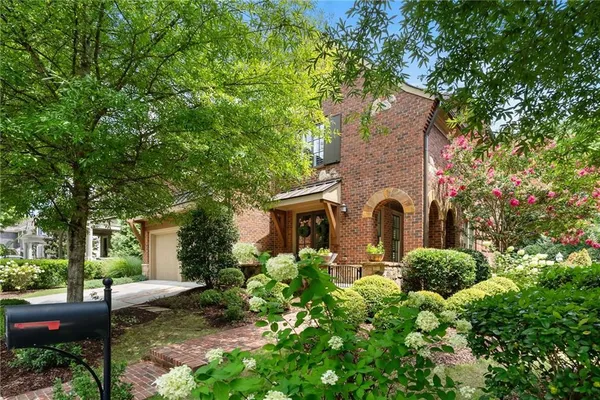 a view of a chair and table in the back yard