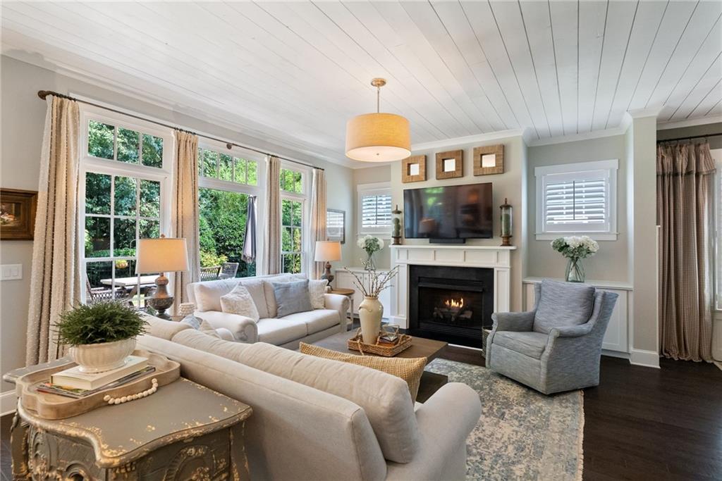7240 Samples Field Road Cumming, GA 30040 - Photo 12 of 84 a living room with furniture a fireplace and a large window
