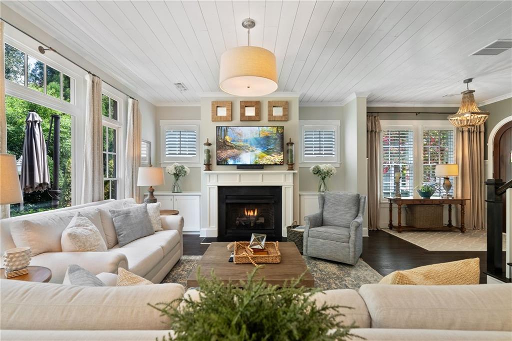 7240 Samples Field Road Cumming, GA 30040 - Photo 13 of 84 a living room with furniture a fireplace and a large window