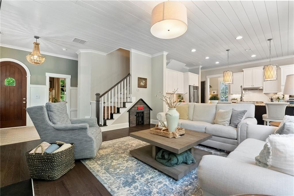 7240 Samples Field Road Cumming, GA 30040 - Photo 16 of 84 a living room with furniture kitchen view and a chandelier