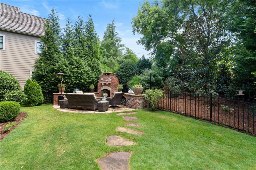 7240 Samples Field Road Cumming, GA 30040 - Photo 2 of 84 a view of a chair and table in the back yard