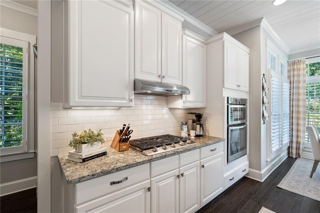7240 Samples Field Road Cumming, GA 30040 - Photo 21 of 84 a kitchen with granite countertop stainless steel appliances white cabinets and a window