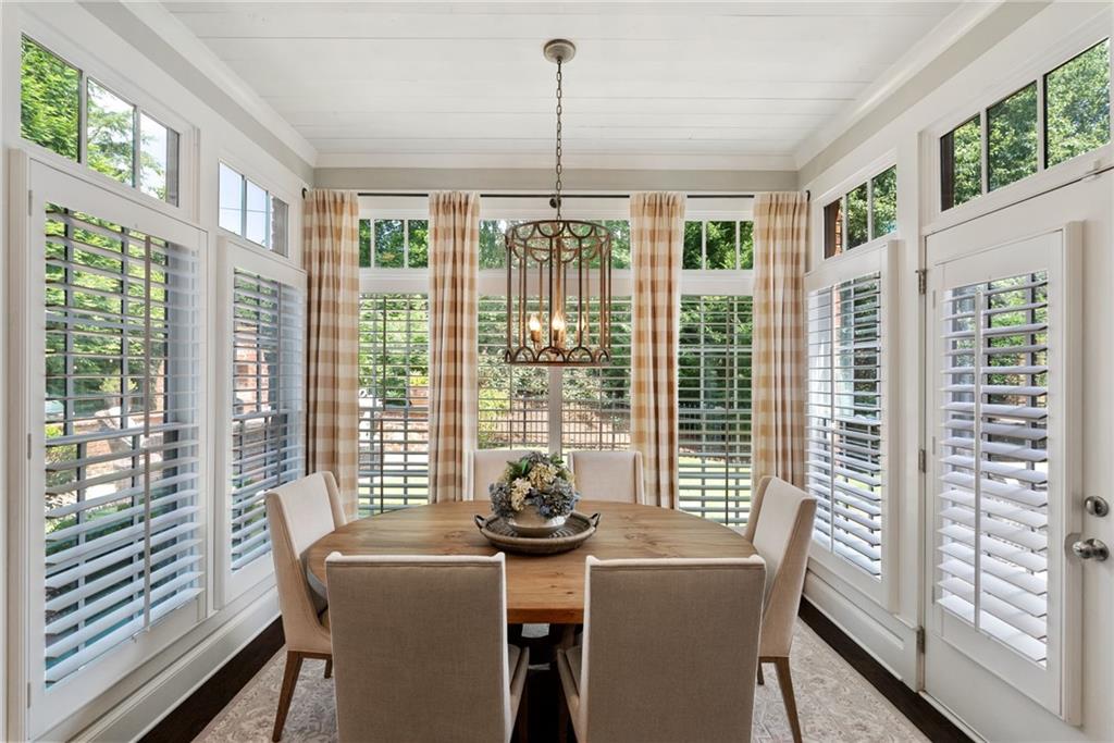 7240 Samples Field Road Cumming, GA 30040 - Photo 23 of 84 a view of a dining room with furniture large windows and wooden floor