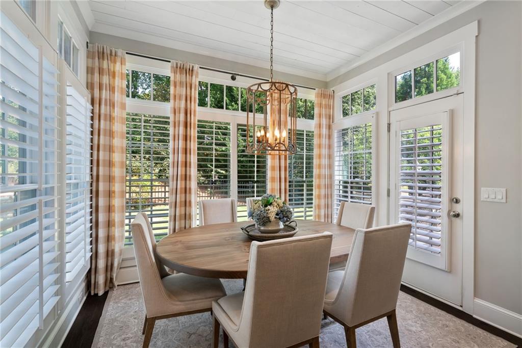 7240 Samples Field Road Cumming, GA 30040 - Photo 24 of 84 a dining room with furniture window wooden floor
