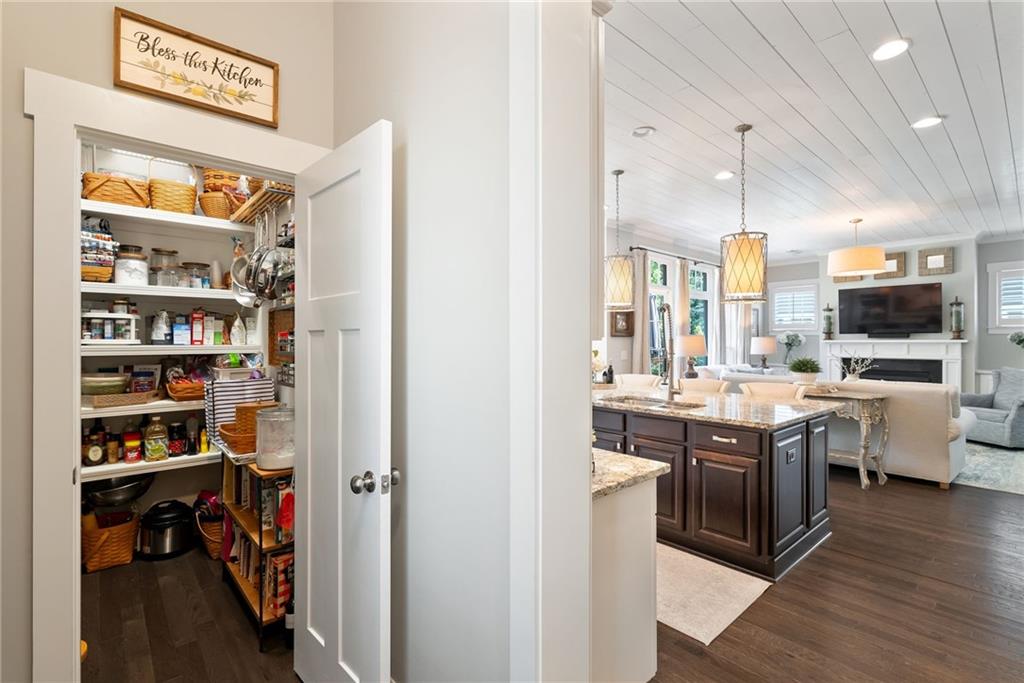 7240 Samples Field Road Cumming, GA 30040 - Photo 26 of 84 a view of a kitchen with cabinets and wooden floor