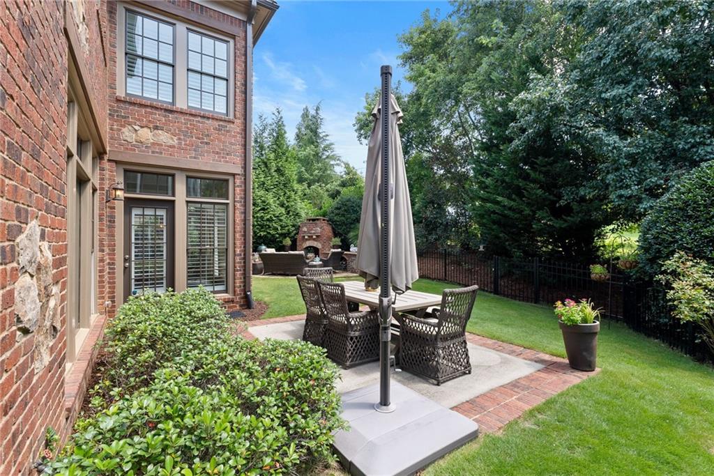 7240 Samples Field Road Cumming, GA 30040 - Photo 3 of 84 a view of a chair and table in backyard of the house