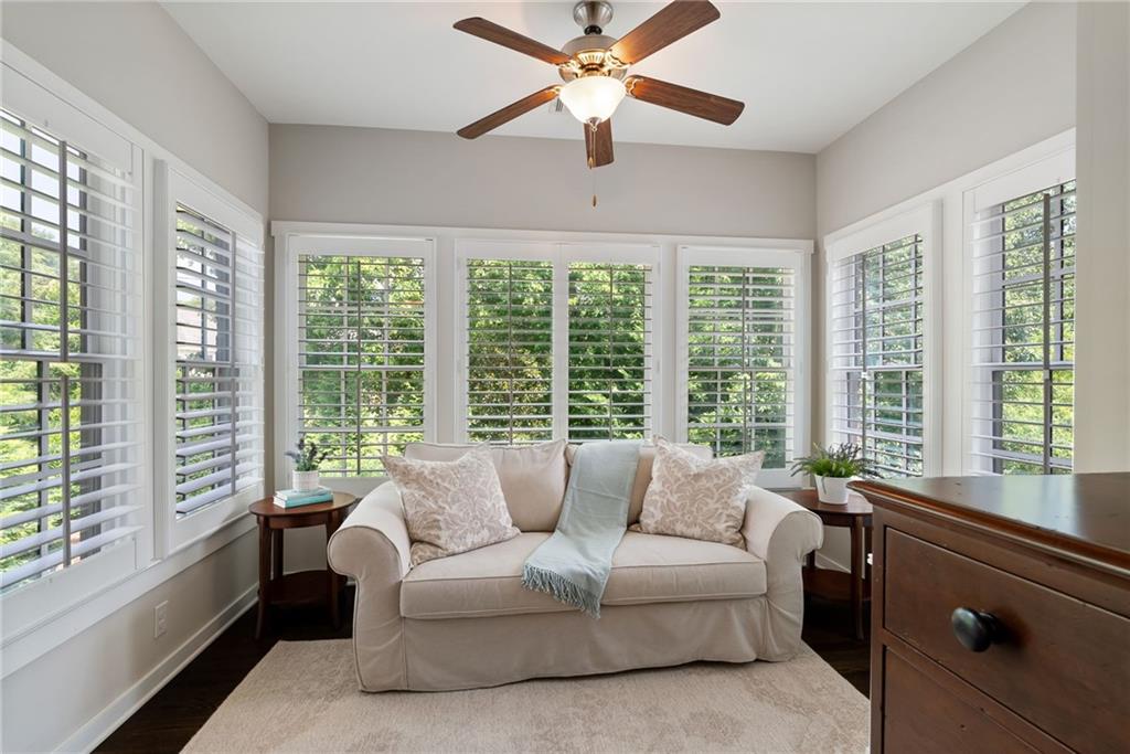 7240 Samples Field Road Cumming, GA 30040 - Photo 35 of 84 a living room with furniture and a large window