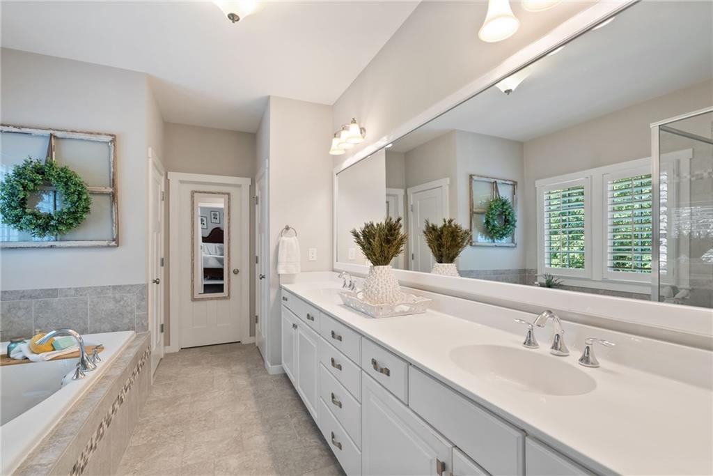 7240 Samples Field Road Cumming, GA 30040 - Photo 37 of 84 a spacious bathroom with a double vanity sink and a mirror