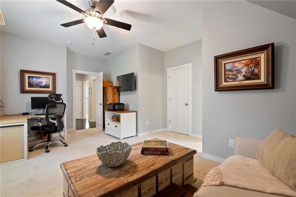 7240 Samples Field Road Cumming, GA 30040 - Photo 39 of 84 a living room with furniture and a flat screen tv