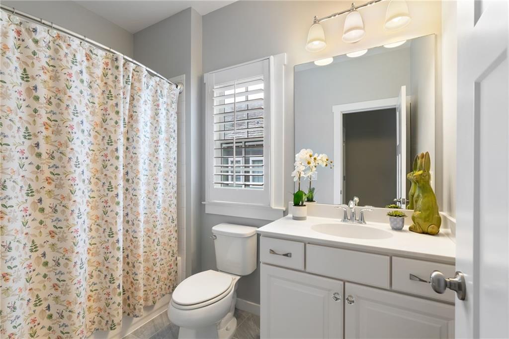 7240 Samples Field Road Cumming, GA 30040 - Photo 40 of 84 a bathroom with a sink a toilet and a mirror