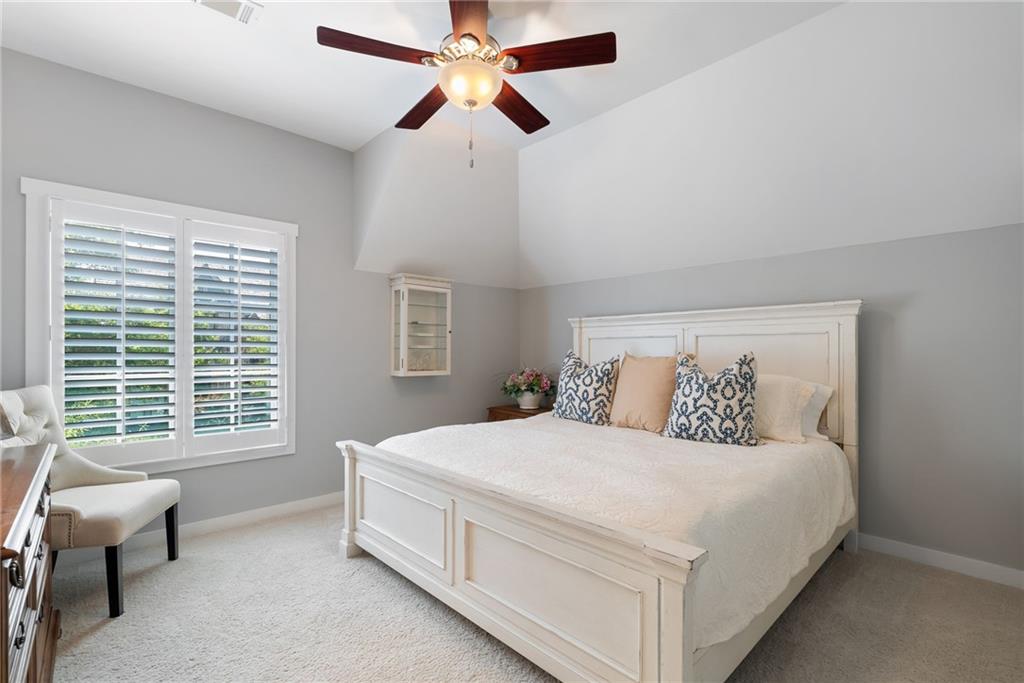 7240 Samples Field Road Cumming, GA 30040 - Photo 41 of 84 a bedroom with a bed and a chandelier