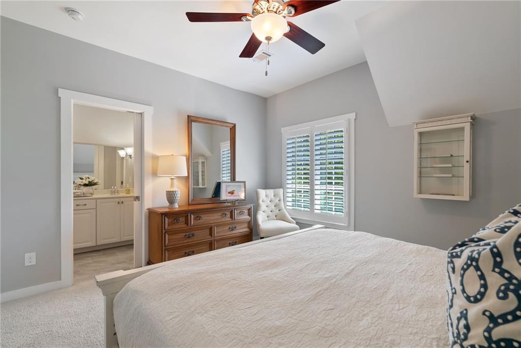 7240 Samples Field Road Cumming, GA 30040 - Photo 42 of 84 a bedroom with a bed and a chandelier