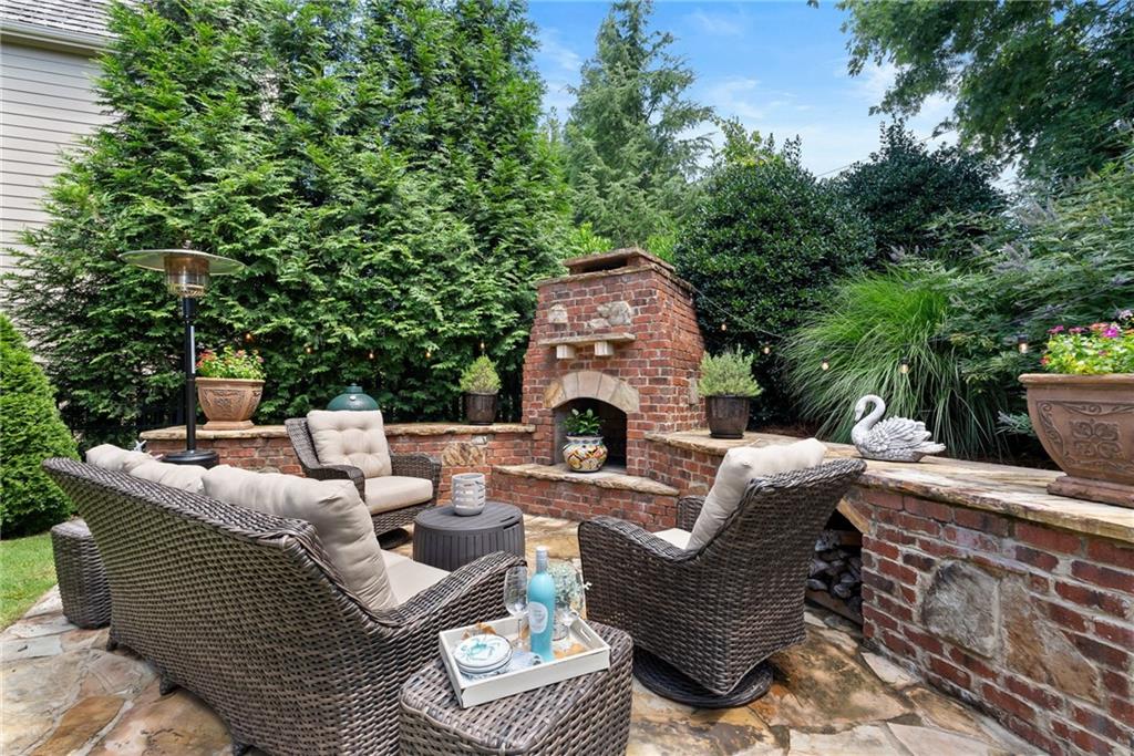 7240 Samples Field Road Cumming, GA 30040 - Photo 52 of 84 a view of a patio with couches and a fireplace