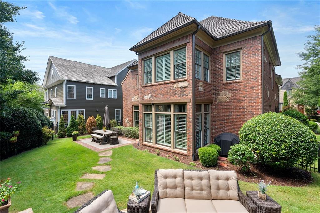 7240 Samples Field Road Cumming, GA 30040 - Photo 53 of 84 a front view of a house with garden and porch