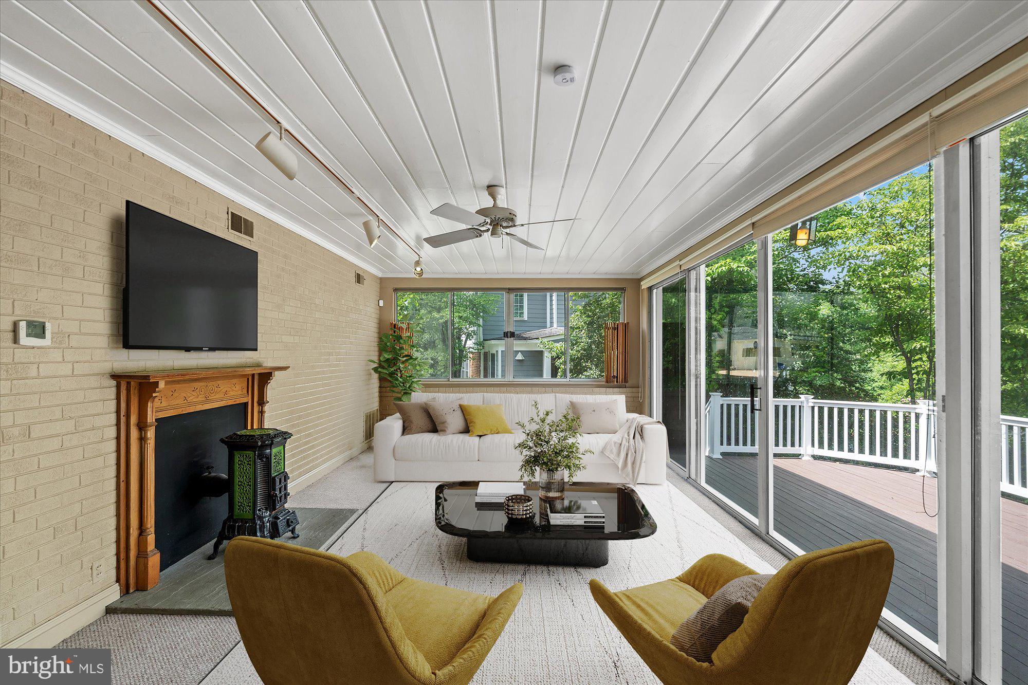 8300 Kerry Road Chevy Chase, MD 20815 - Photo 11 of 42 a living room with furniture a fireplace and a flat screen tv