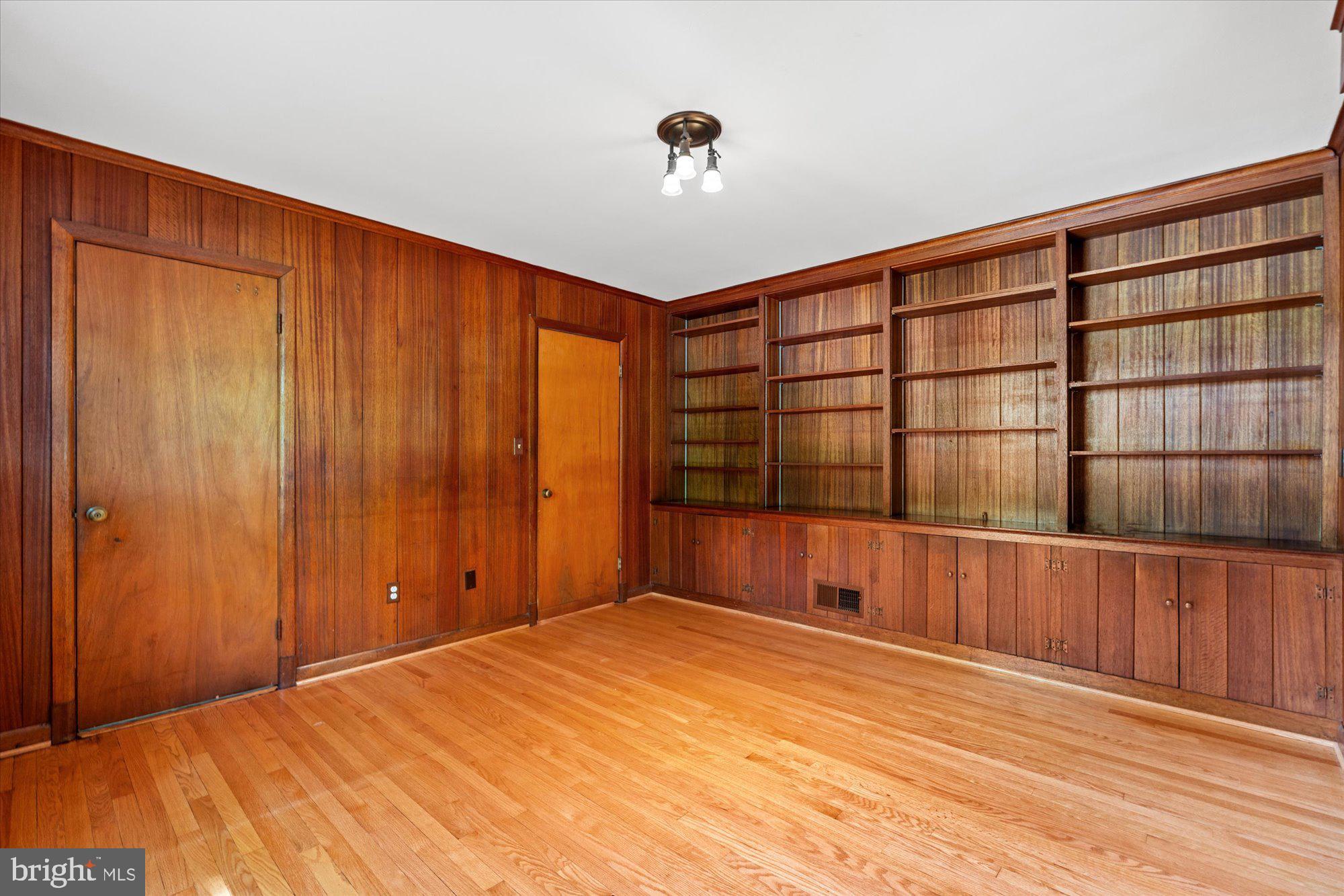 8300 Kerry Road Chevy Chase, MD 20815 - Photo 16 of 42 a view of an empty room with wooden floor and a window