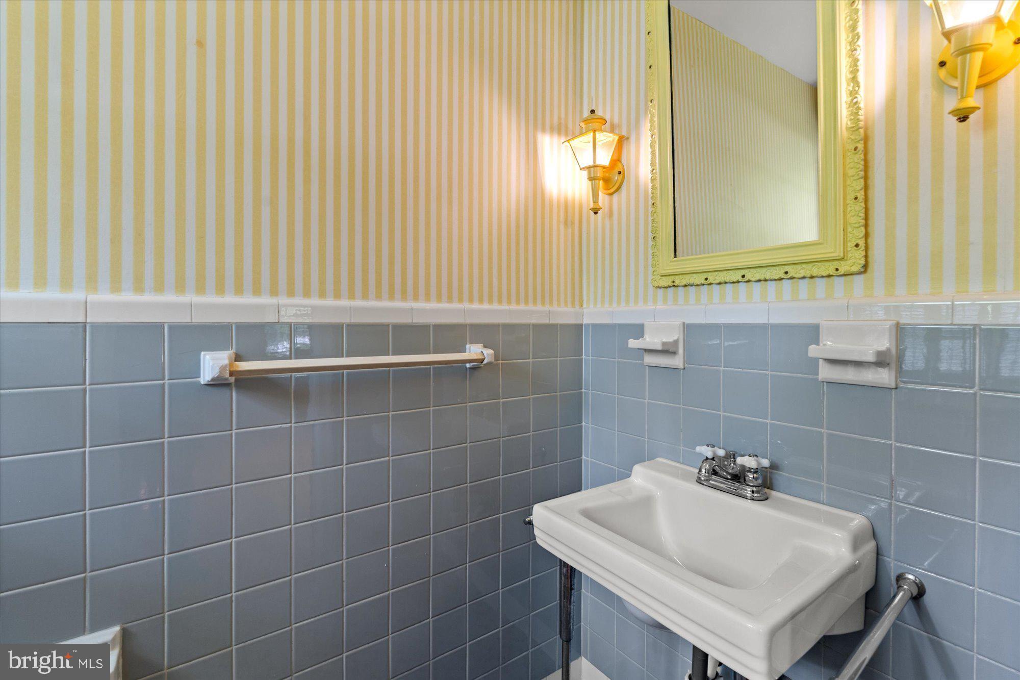 8300 Kerry Road Chevy Chase, MD 20815 - Photo 17 of 42 a bathroom with a sink a mirror and a toilet