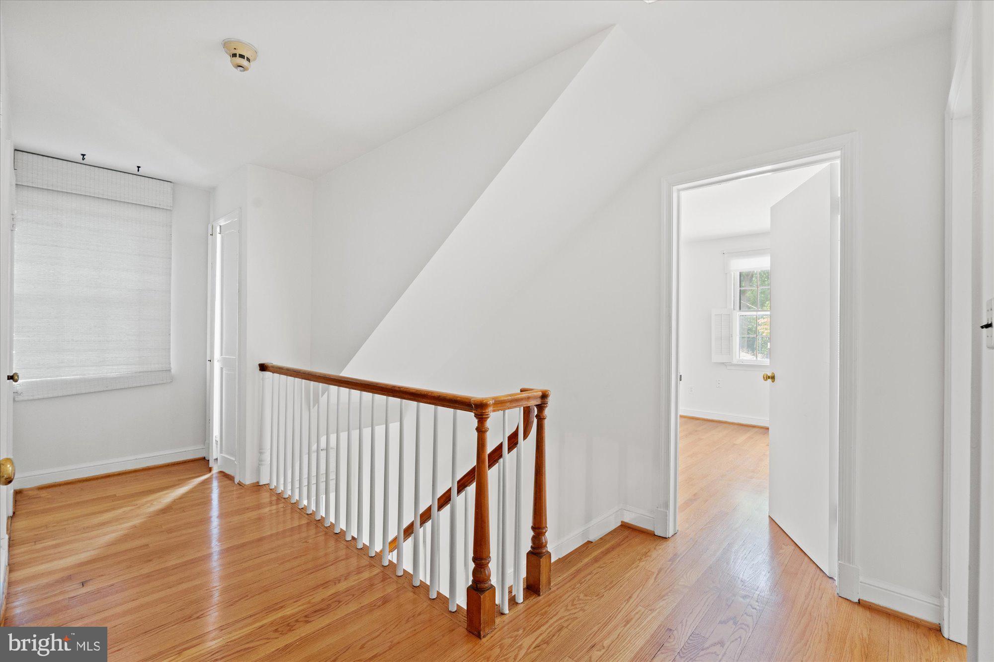 8300 Kerry Road Chevy Chase, MD 20815 - Photo 21 of 42 a view of a hallway with wooden floor and a bathroom