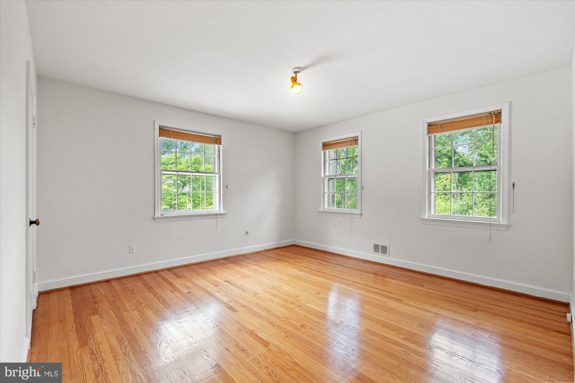 8300 Kerry Road Chevy Chase, MD 20815 - Photo 26 of 42 wooden floor in an empty room with a window