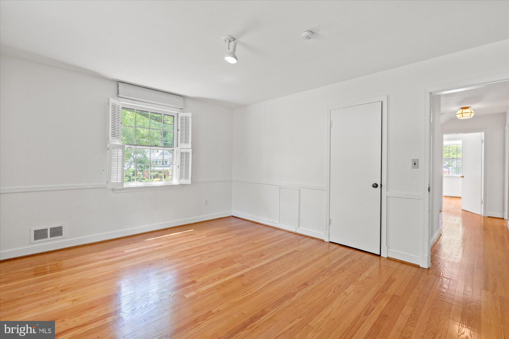 8300 Kerry Road Chevy Chase, MD 20815 - Photo 27 of 42 wooden floor in an empty room with a window