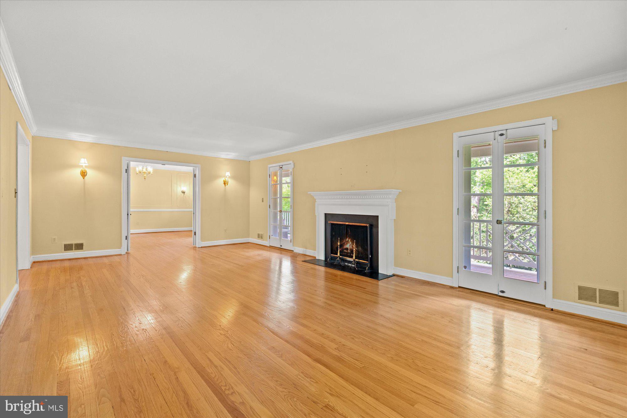 8300 Kerry Road Chevy Chase, MD 20815 - Photo 6 of 42 a view of empty room with wooden floor and fireplace