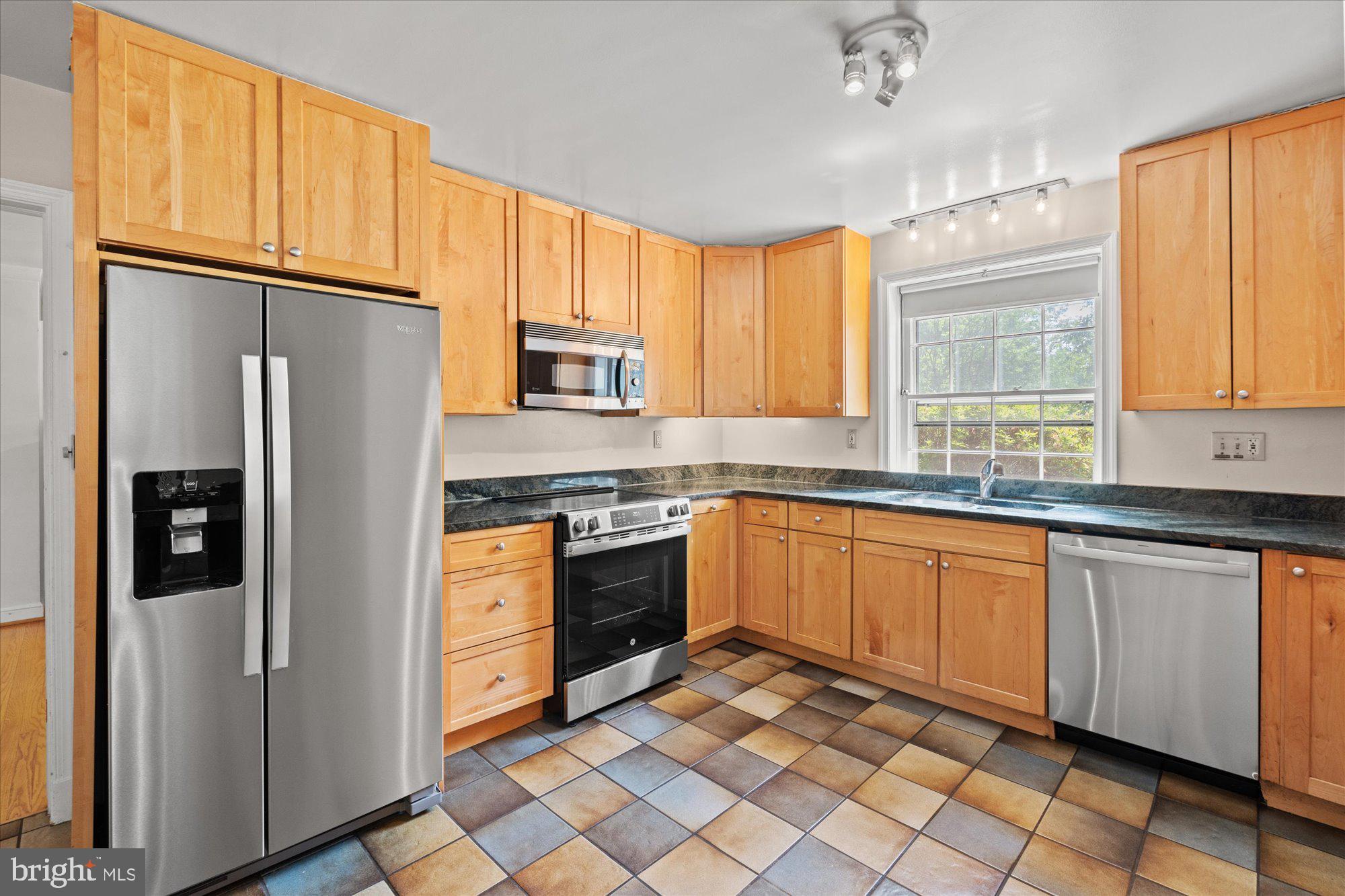 8300 Kerry Road Chevy Chase, MD 20815 - Photo 9 of 42 a kitchen with stainless steel appliances granite countertop a refrigerator sink and cabinets