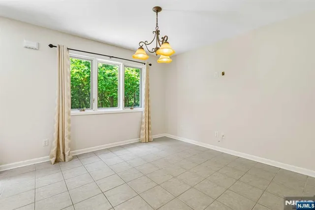 an empty room with windows and outdoor view