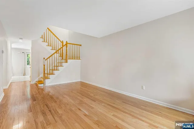 a view of an entryway with wooden floor