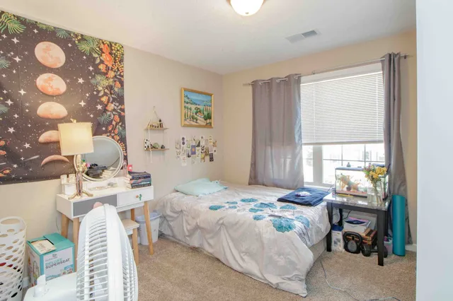 a bedroom that has a bed and a window