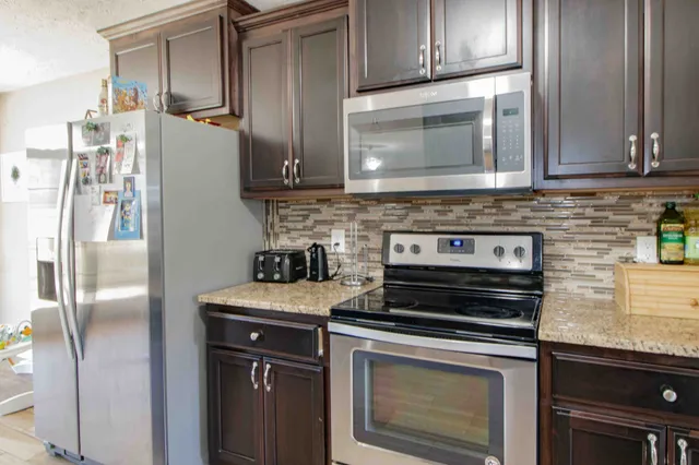a kitchen with a stove microwave and refrigerator