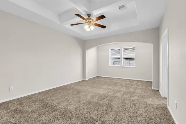 an empty room with closet and windows