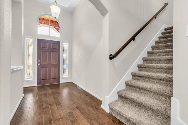 a view of an entryway with wooden floor