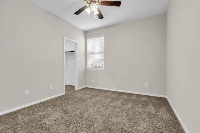 an empty room with a empty space and windows