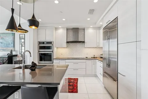 a kitchen with granite countertop a sink and cabinets