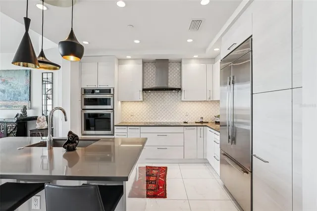 a kitchen with granite countertop a sink and cabinets