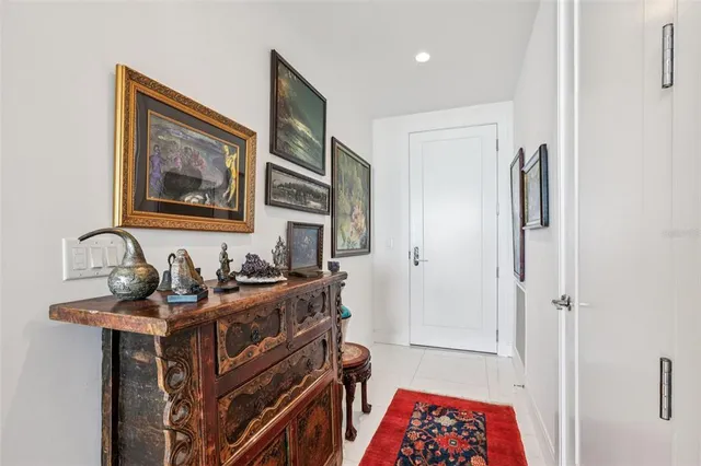 a bedroom with a bed a painting on the wall and a large window